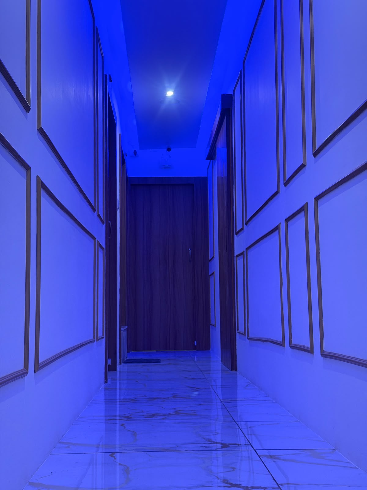 Warm mood-lit hallway leading to private treatment rooms at KEVA Luxury Spaa, Hennur